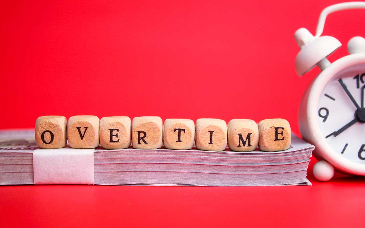 bell-clock-and-small-wooden-cube-with-the-word-ove-2023-01-06-22-27-55-utc
